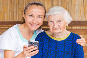 Photo of elderly women with her caregiver
